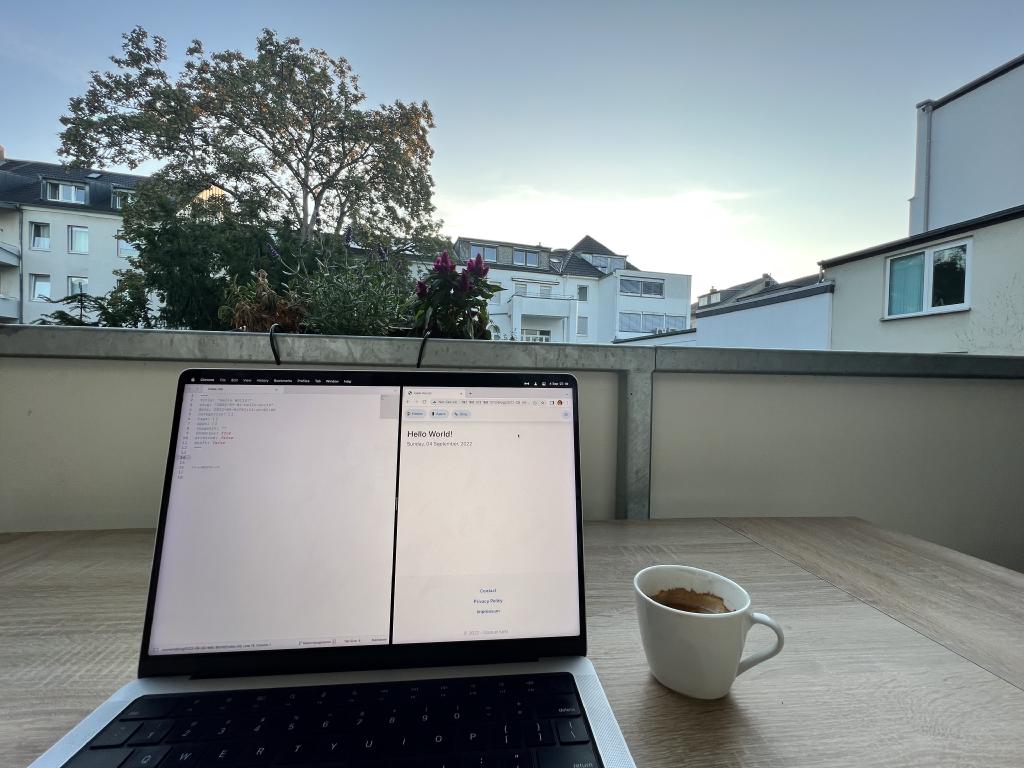 A view of our balcony in our Bonn apartment where I'm watching the sunrise and writing my first blog post for the new website. There's a cup of freshly brewed espresso next to my Laptop.